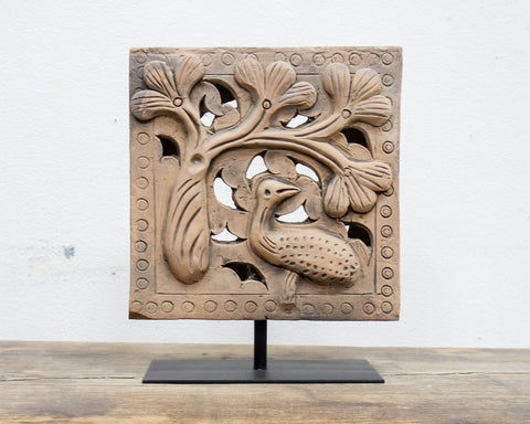 Antique brick with bird in a pine tree